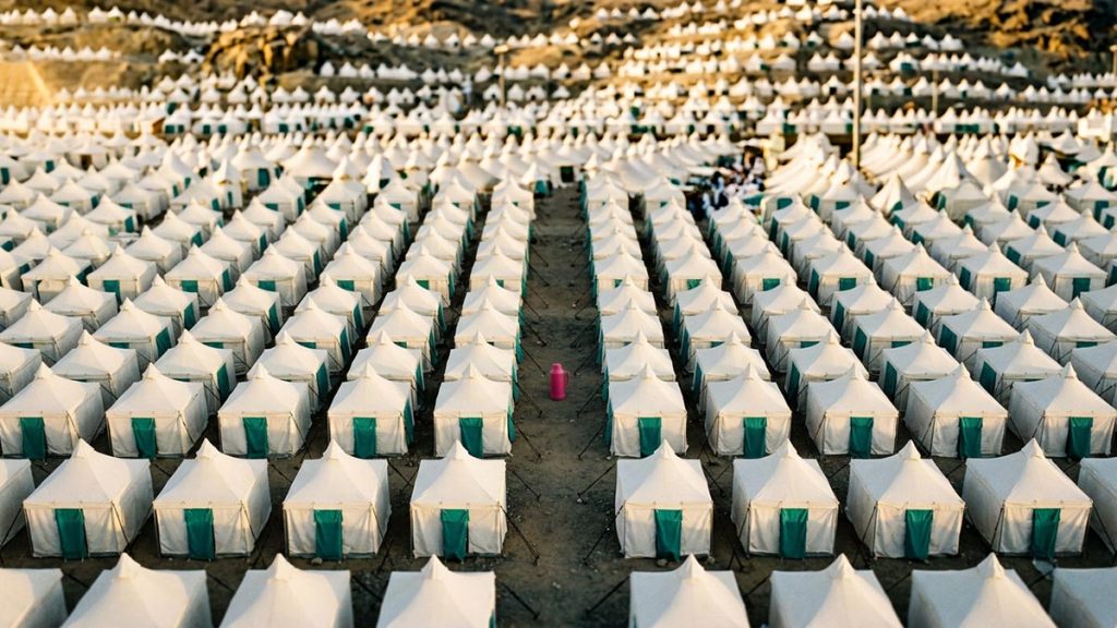 A still-life of rows of white pilgrim tents stretching across the valley, illustrating the Dua at Mina.