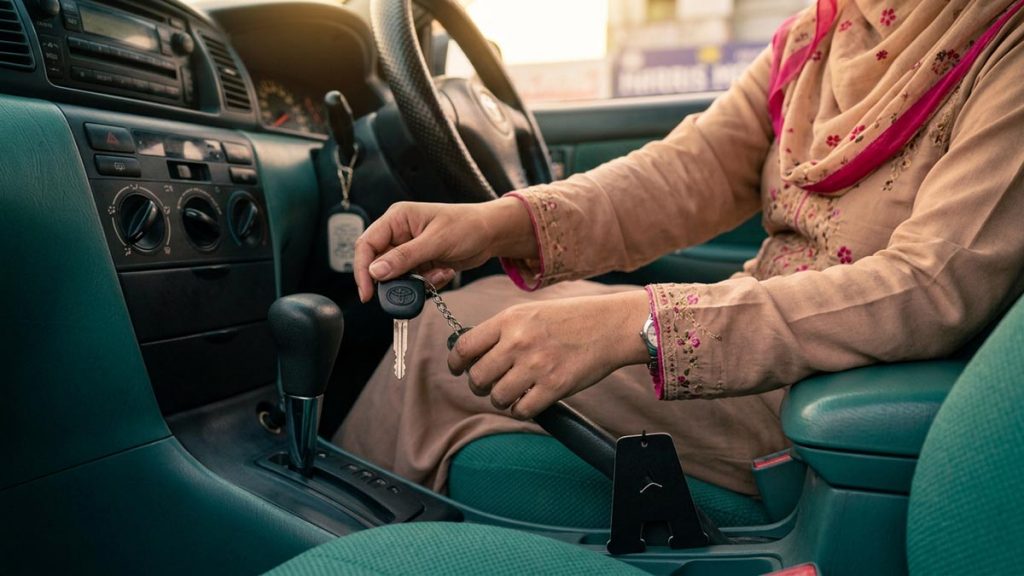 Close view of a Muslim woman's hands and the car keys during the Dua Before Driving.