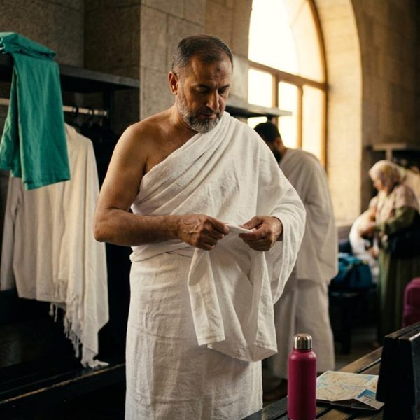 A Muslim pilgrim making the Dua Before Entering Ihram, at a station where pilgrims prepare for pilgrimage.