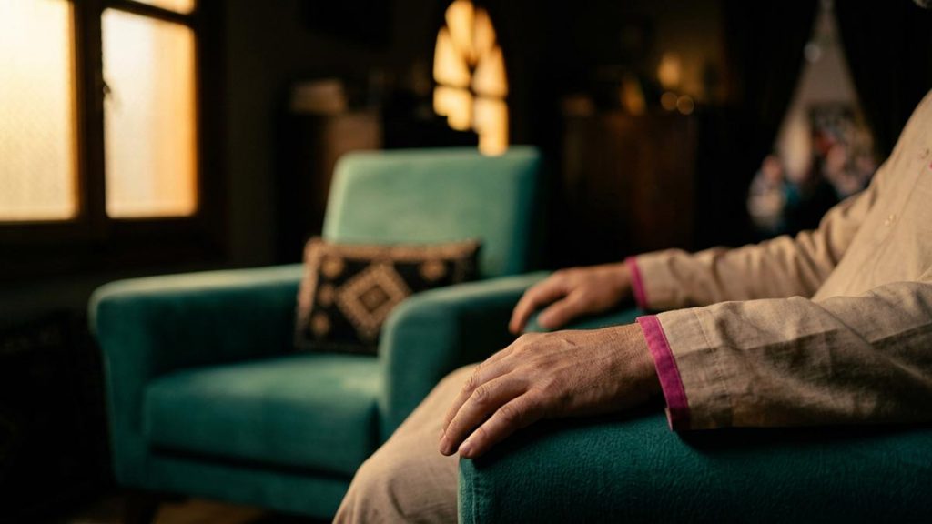 Close view of a Muslim man's hands and the two empty chairs during the Dua During Family Disputes.