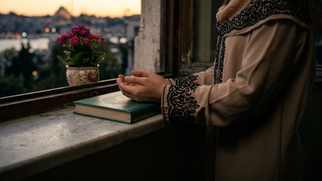 Close view of a Muslim woman's hands and the window during the Dua for a Good Ending.