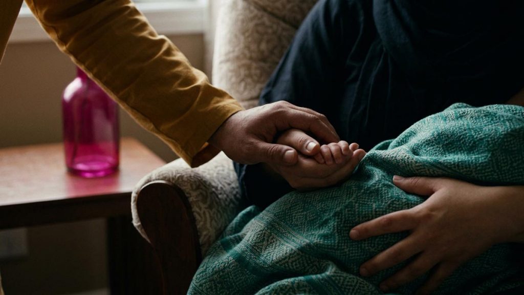 Close view of a Muslim family's hands and the nursing chair during the Dua for Breastfeeding Mothers.