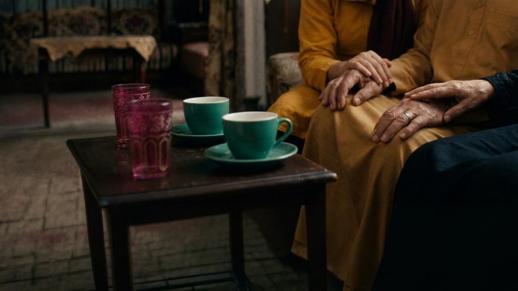 Close view of a Muslim family's hands and the two teacups during the Dua for Parents.