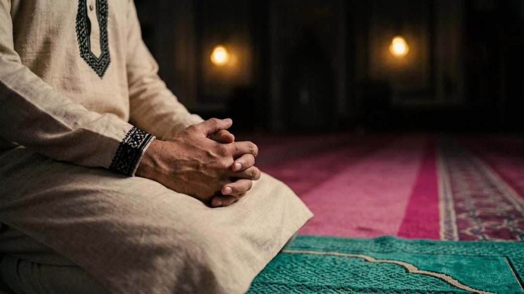 Close view of a Muslim man's hands and the single prayer mat alone during the Dua for Sincerity in Worship.