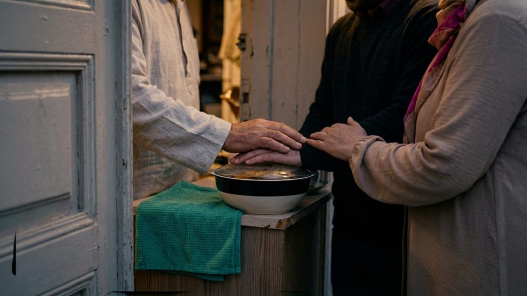 Close view of a Muslim family's hands and the covered dish of food during the Dua of Condolence.