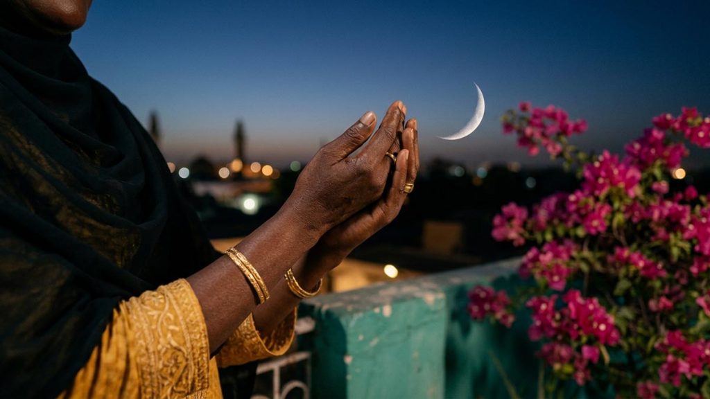 Close view of a Muslim woman's hands and the thin crescent moon during the Dua Upon Seeing the New Moon.