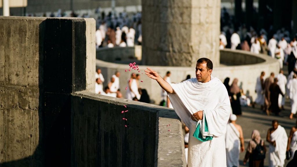 A Muslim pilgrim at the pillars where the pilgrimage rite of throwing is performed, an opening scene for the Dua When Throwing the Jamarat.