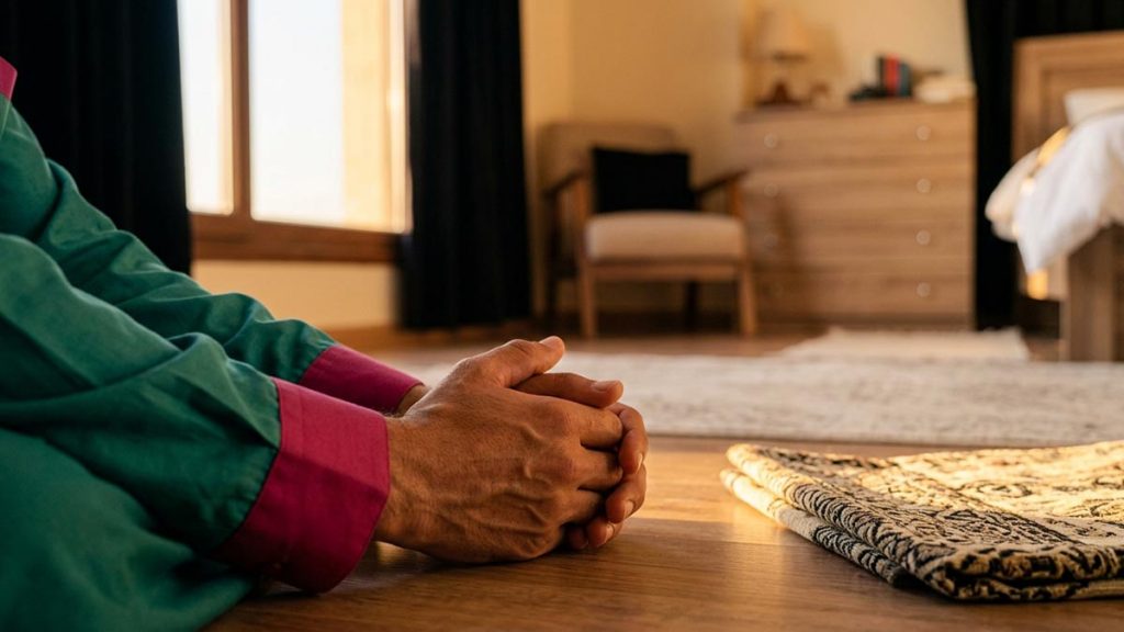 Close view of a Muslim man's hands and the folded prayer mat during the Morning Dua.