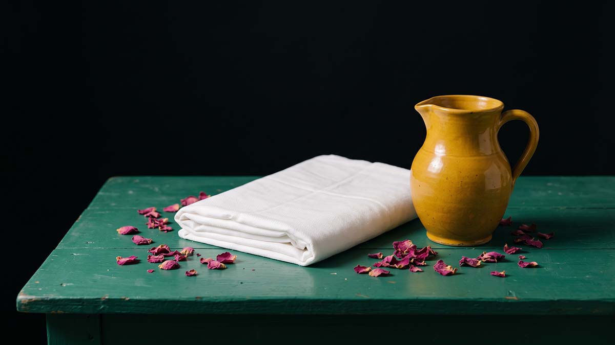 White cotton shroud and water jug for Islamic Ghusl preparation