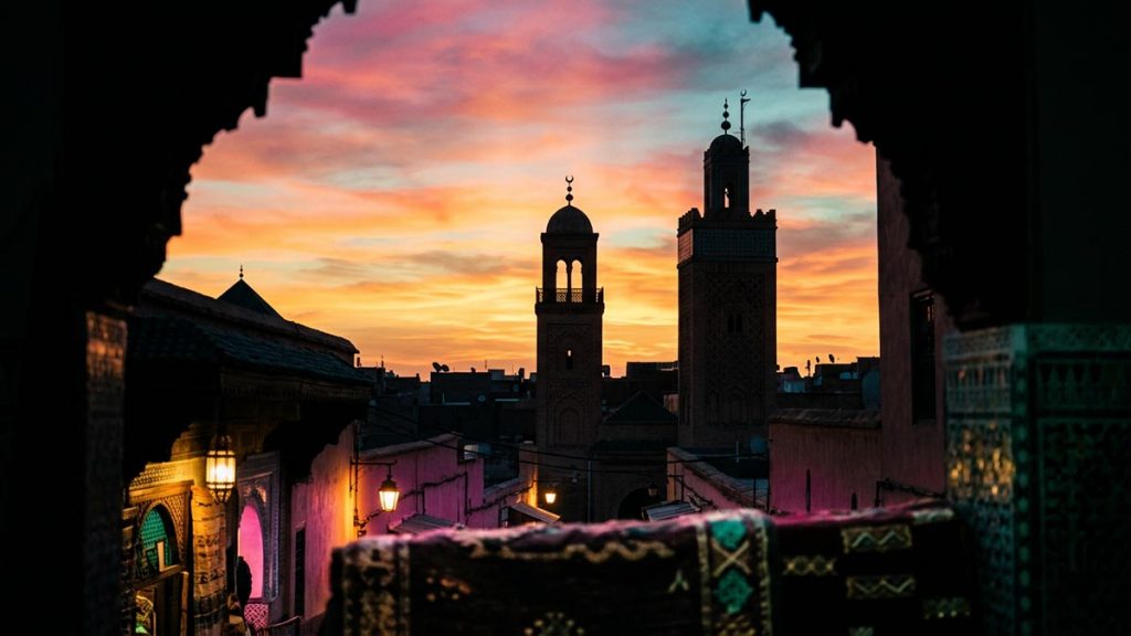 The silhouette of a minaret against a vast glowing sky at first light, evoking the meaning of Allahu Akbar.