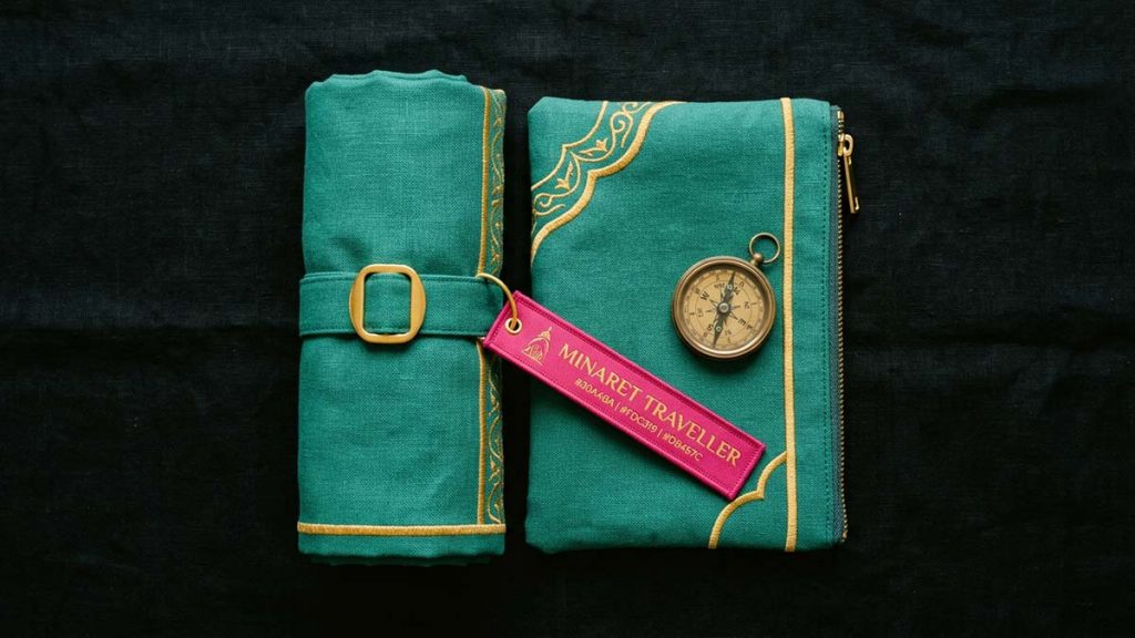 A rolled Travel Prayer Mat with its pouch and a compass