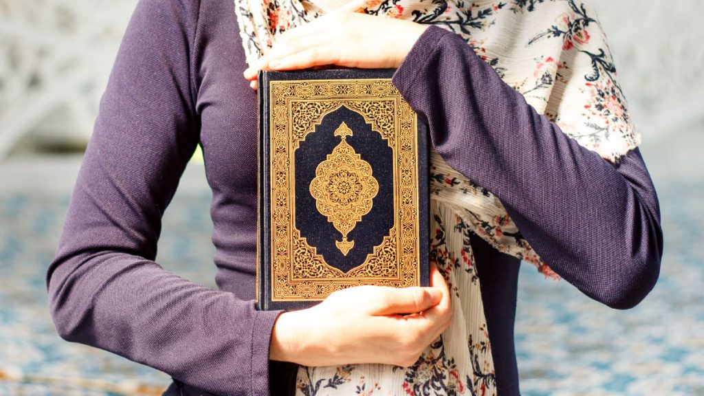 Muslim holding the Holy Quran.